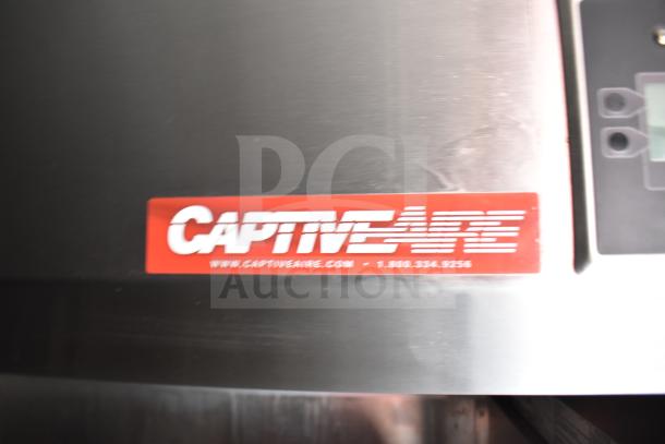 CaptiveAire hood label on 2021 Rock Solid Cargo 28ft food trailer, featuring Henny Penny fryer and Taylor griddle.