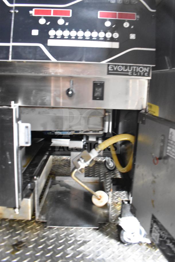 Interior view of the 2021 Rock Solid Cargo food trailer featuring an Evolution Elite fryer. Notable for its commercial-grade kitchen equipment, including a Henny Penny electric fryer.