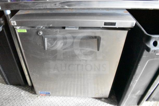 Stainless steel refrigerator in a 2021 Rock Solid Cargo 28ft food trailer, featuring a natural refrigerant tag.