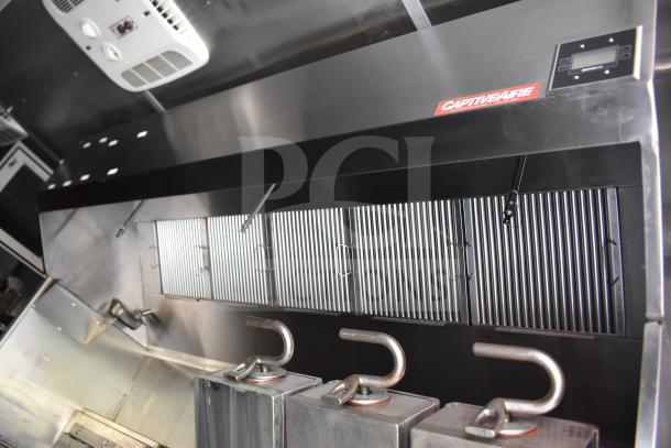 Interior of 2021 Rock Solid Cargo 28ft food trailer; CaptiveAire hood system visible, used for commercial kitchen ventilation.