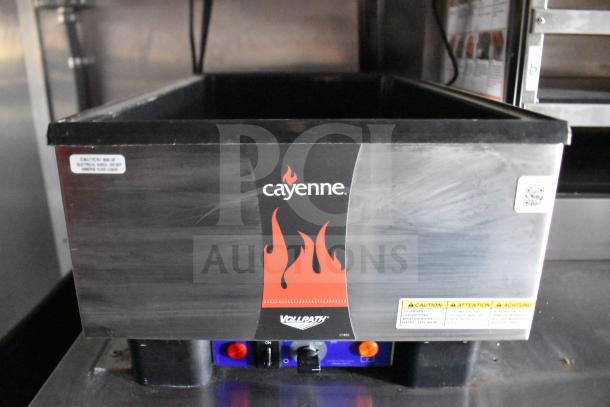 Vollrath Cayenne electric food warmer, stainless steel with caution labels, switches visible, part of trailer equipment.