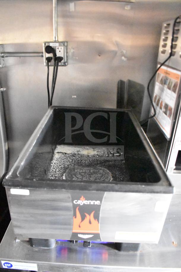 Interior of 2021 Rock Solid Cargo 28ft food trailer showing Cayenne electric fryer. Features NSF label, clean condition.