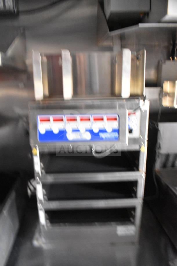 2021 Rock Solid Cargo food trailer interior with fryers, Taylor griddle, and CaptiveAire hood visible.
