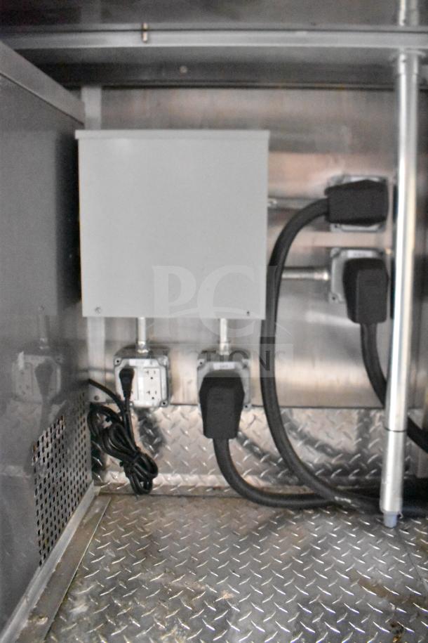 Electrical outlets and wiring inside a 2021 Rock Solid Cargo 28ft food trailer. Diamond plate floor visible.