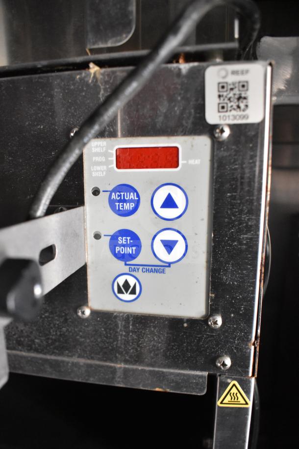 Control panel of the 2021 Rock Solid Cargo food trailer. Features temperature settings, QR code, and caution sign.