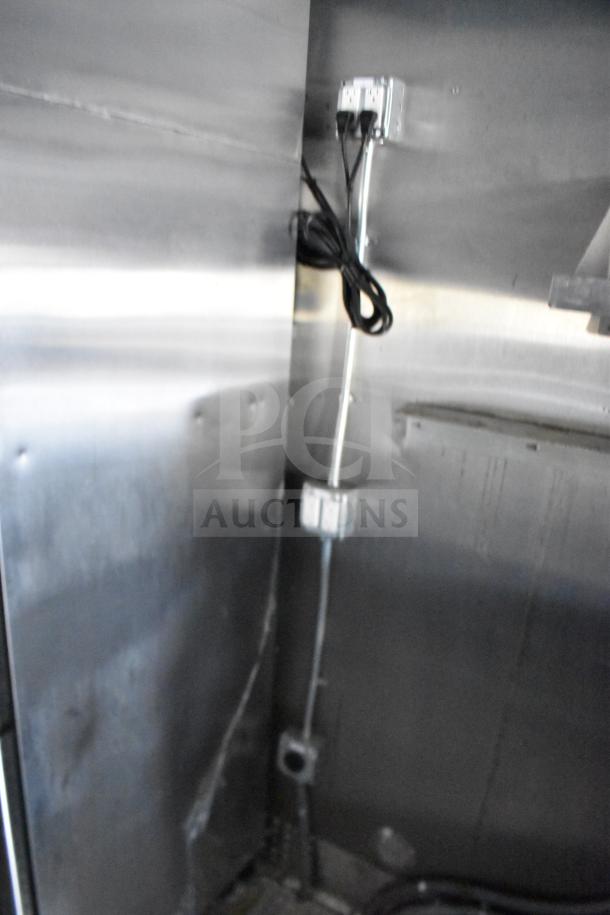 Interior view of 2021 Rock Solid Cargo 28ft food trailer showing electric wiring and metal paneling, indicating utility setup.