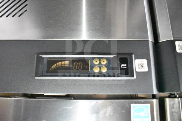 Control panel on a commercial food trailer freezer by MS, showing temperature settings, with QR codes and a ventilation grill.