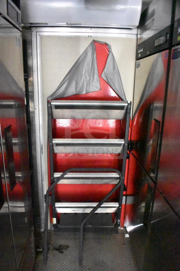 Interior of 2021 Rock Solid Cargo food trailer, featuring stainless steel shelving and refrigeration units.