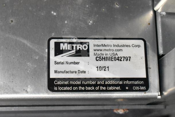 Label on a Metro equipment part. Serial: C5HME042797, Manufactured: 10/21, by InterMetro Industries, USA.