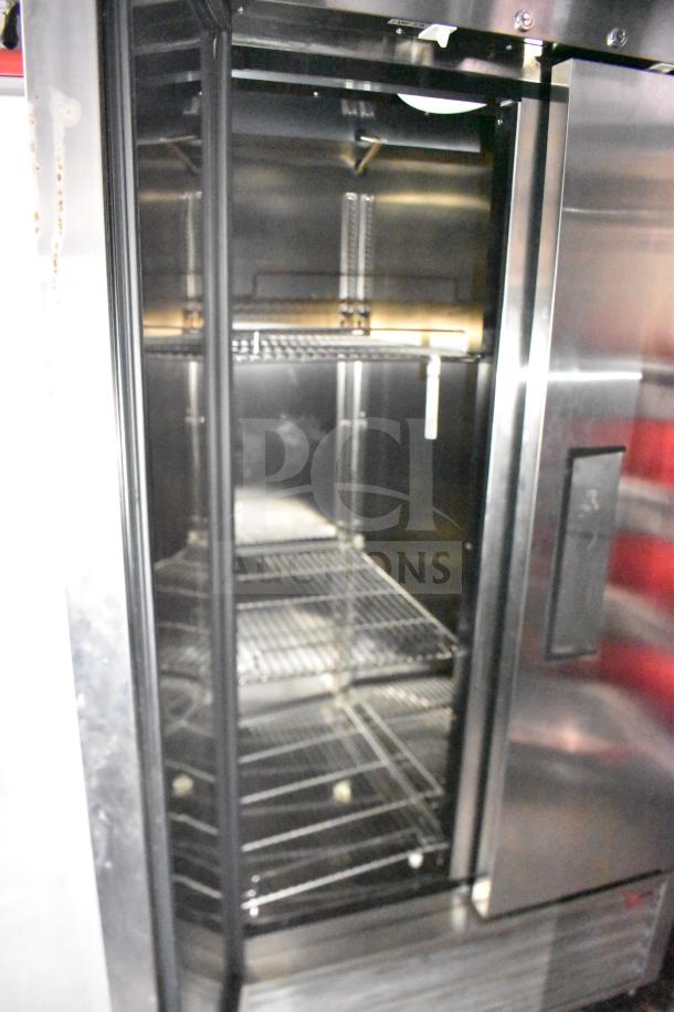 Interior view of a Rock Solid Cargo 28ft food trailer refrigerator. Features wire shelving and stainless steel interior.