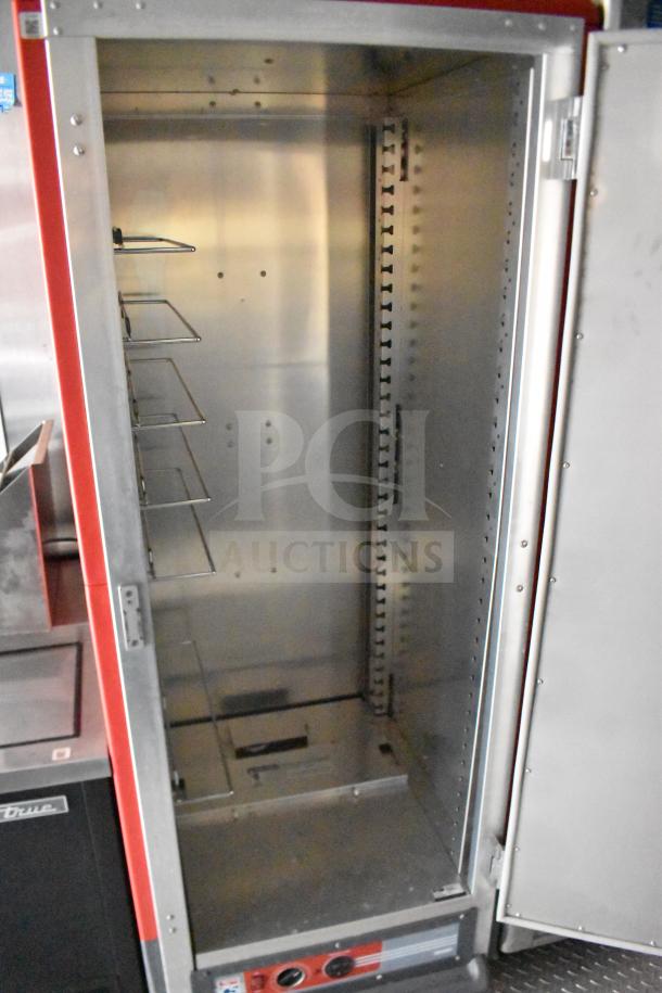 Open stainless steel commercial food warmer inside 2021 Rock Solid Cargo food trailer, shelving visible, clean condition.