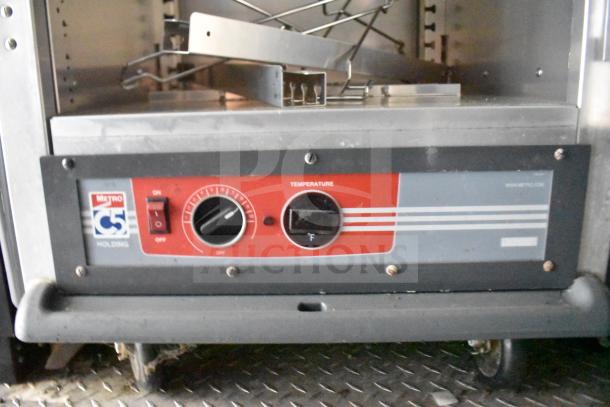 Rock Solid Cargo food trailer's Metro C5 holding cabinet with temperature control and on/off switch, visible markings.