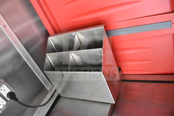 Metal organizer inside a 2021 Rock Solid Cargo food trailer. Triangular dividers, stainless steel finish.
