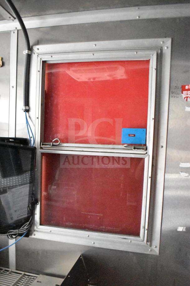 2021 Rock Solid Cargo 28ft food trailer interior window, red trim, wiring visible. Features commercial-grade kitchen setup.