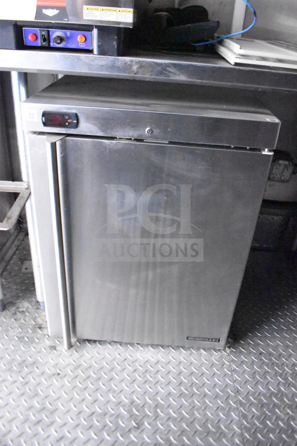 Stainless steel Hoshizaki under-counter refrigerator in excellent condition on diamond plate flooring.