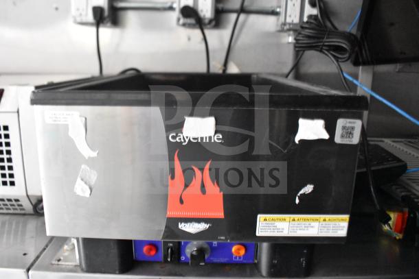 Cayenne electric fryer in Rock Solid Cargo 28ft food trailer. Visible caution labels and power buttons.
