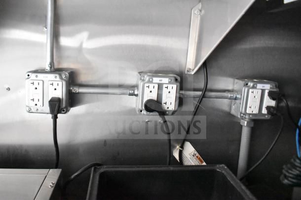 Electrical outlets inside a 2021 Rock Solid Cargo 28ft Triple-Axle Commercial Food Trailer, featuring multiple power connections.
