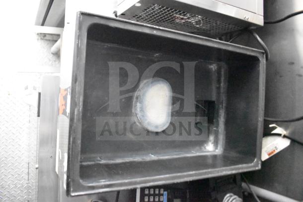 Interior view of a 2021 Rock Solid Cargo food trailer showing a deep fryer section with visible wear, part of its commercial kitchen setup.