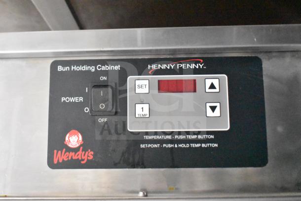 Control panel of Henny Penny Bun Holding Cabinet with power switch, temperature settings, and Wendy's logo.