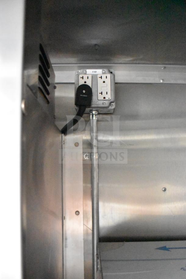 Electrical outlet inside the 2021 Rock Solid Cargo 28ft food trailer, showcasing new stainless steel interior.