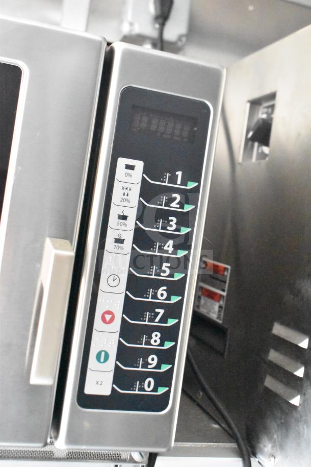 Control panel of a commercial kitchen appliance in a 2021 Rock Solid Cargo food trailer, featuring numeric keypad and indicator lights.