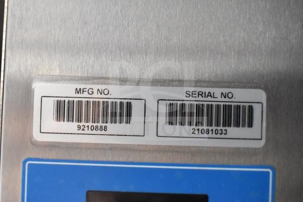 Close-up of manufacturer and serial number labels on a 2021 Rock Solid Cargo 28ft triple-axle food trailer. MFG No: 9210888, Serial No: 21081033.