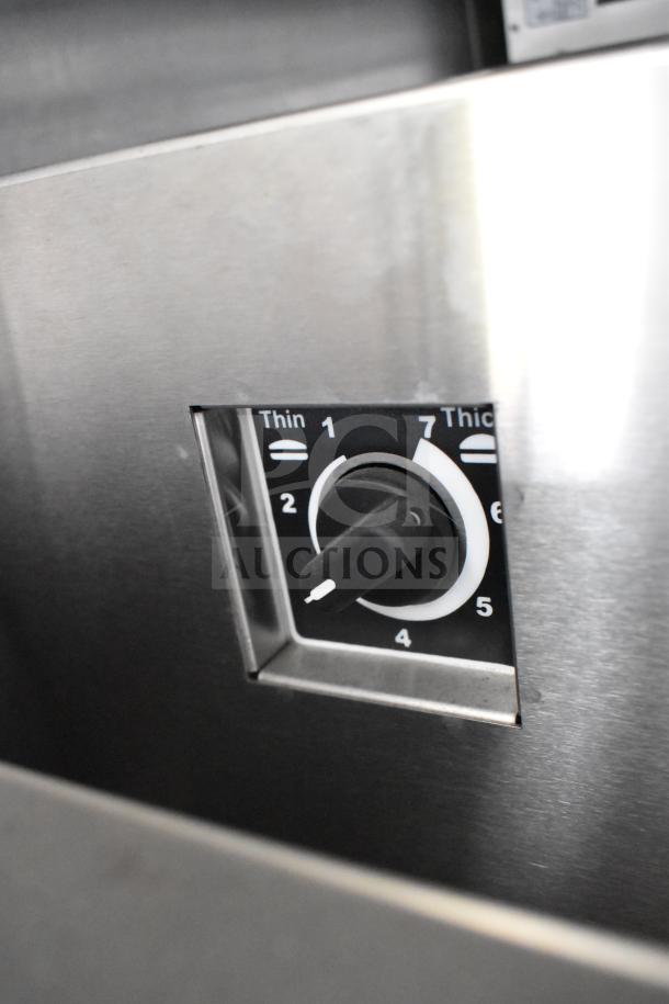 Close-up of a stainless steel control knob showing thickness settings from 1 to 7, part of the 2021 Rock Solid Cargo food trailer equipment.