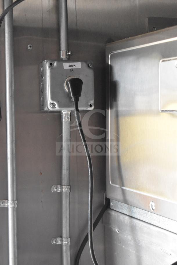 Electrical outlet inside 2021 Rock Solid Cargo 28ft food trailer. Visible wiring and plug, labeled "68A," indicate power setup.