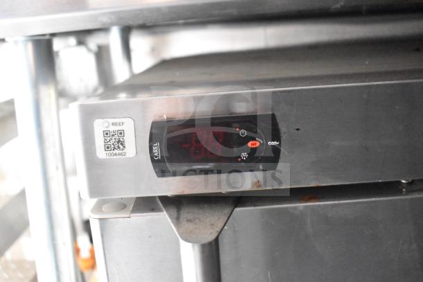 Close-up of an electronic panel inside a 2021 Rock Solid Cargo 28ft food trailer, featuring a Carel display, QR code, and serial number 1004462.