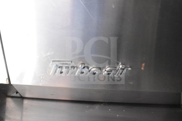 "Turbo Air" branding on stainless steel appliance, showing slight rust and wear, part of a 2021 Rock Solid Cargo food trailer.