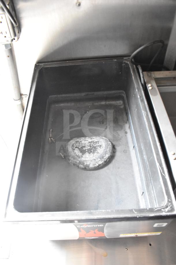 Interior view of 2021 Rock Solid Cargo food trailer showing a storage compartment. Visible is electrical wiring on the wall.