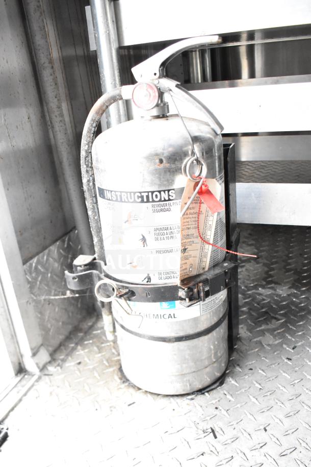 Fire extinguisher inside 2021 Rock Solid Cargo 28ft food trailer. Visible tag, chemical type, and instructions label.