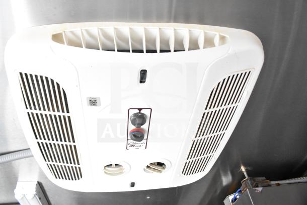 Roof-mounted air conditioning unit in 2021 Rock Solid Cargo 28ft food trailer, featuring vents and control knobs.