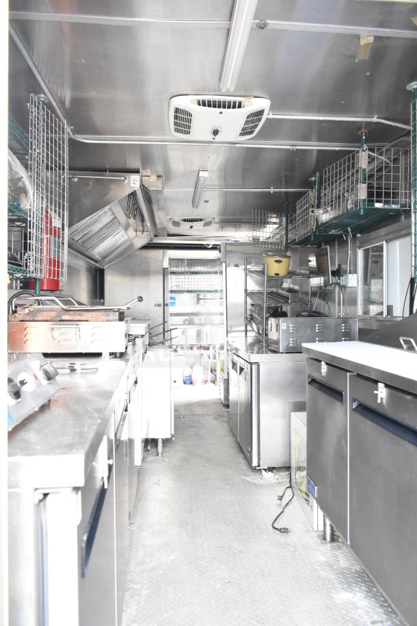 NBRHD Kitchens food trailer with dual Pitco gas fryers, CaptiveAire hood, Arctic Air refrigeration, and Daikin mini-split.