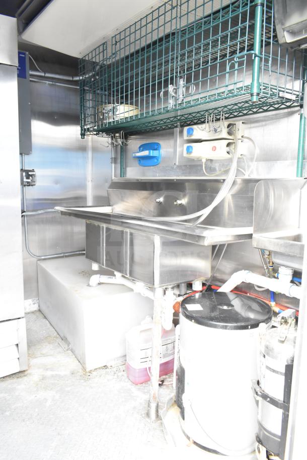 NBRHD Kitchens food trailer interior with stainless steel sink, Arctic Air refrigeration, and CaptiveAire vent system.