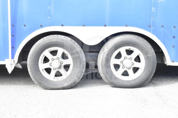 NBRHD Kitchens Food Trailer, blue exterior, dual tires visible. Features dual Pitco fryers, CaptiveAire hood, Arctic Air refrigeration, Daikin mini-split.