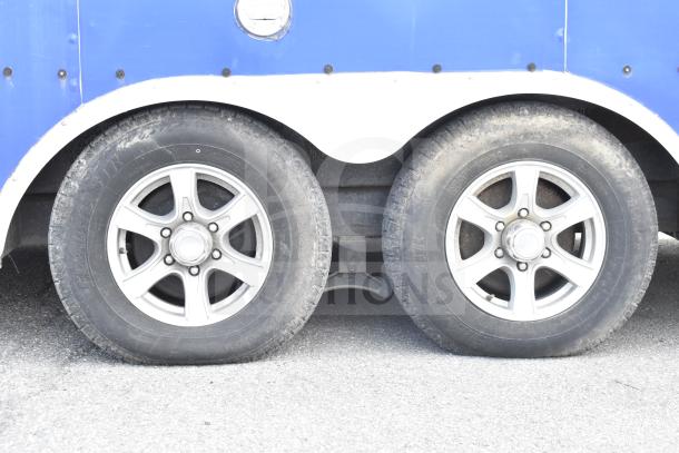 NBRHD food trailer wheels showing tire condition; for Ghost Kitchen trailer with dual Pitco fryers, refrigeration.