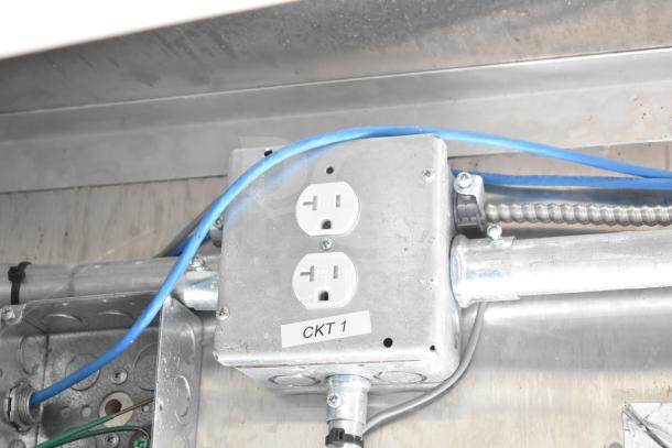 Electrical outlet labeled "CKT 1" inside a food trailer, part of an NBRHD Kitchens Ghost Kitchen setup.