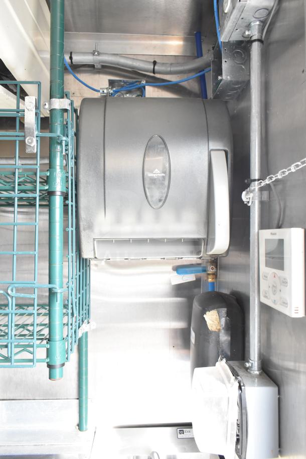 NBRHD Kitchens Ghost Kitchen Food Trailer interior featuring a Georgia-Pacific paper towel dispenser, wiring, and Daikin thermostat.