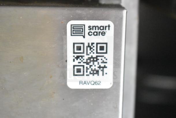 QR code and label on metal surface, showing "smart care" and code "RAVQ62".