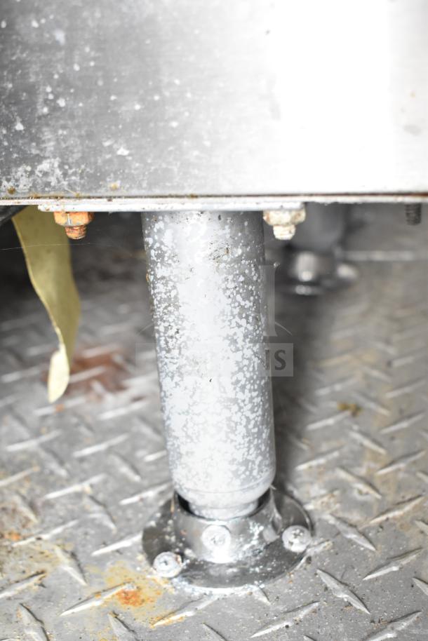 Metal support pole on a diamond plate floor inside the NBRHD Kitchens Ghost Kitchen Food Trailer.