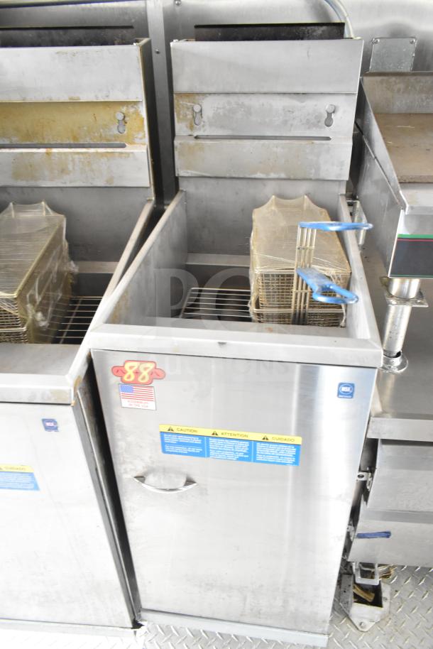 NBRHD Kitchens food trailer with dual Pitco gas fryers, CaptiveAire hood system, and labels indicating manufacturing details.