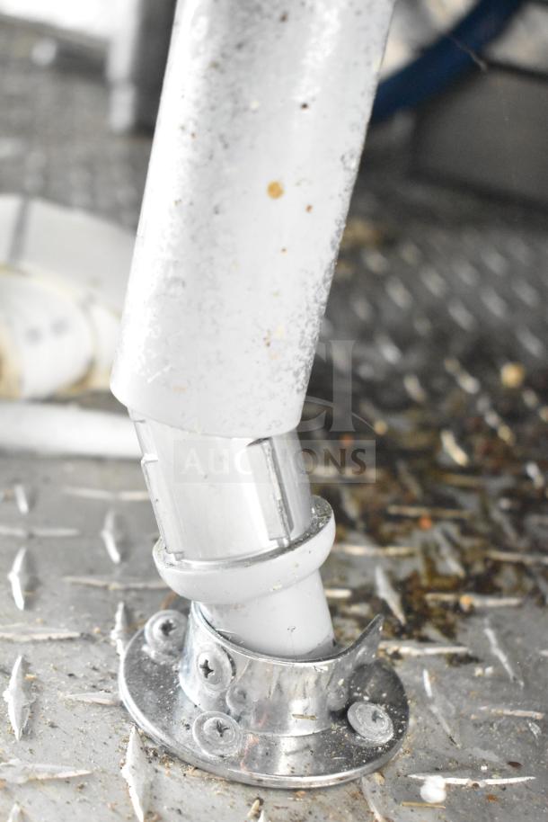 Food trailer interior showing a metal floor mount and pipe connection, part of a NBRHD Kitchens Ghost Kitchen setup.