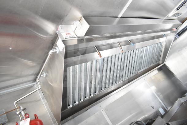 NBRHD Kitchens food trailer interior with CaptiveAire hood, showcasing stainless steel finish and integrated fire suppression system.