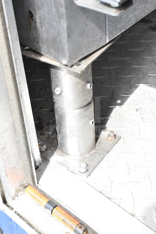 Metal support structure inside NBRHD Kitchens Ghost Kitchen food trailer, showing wear.