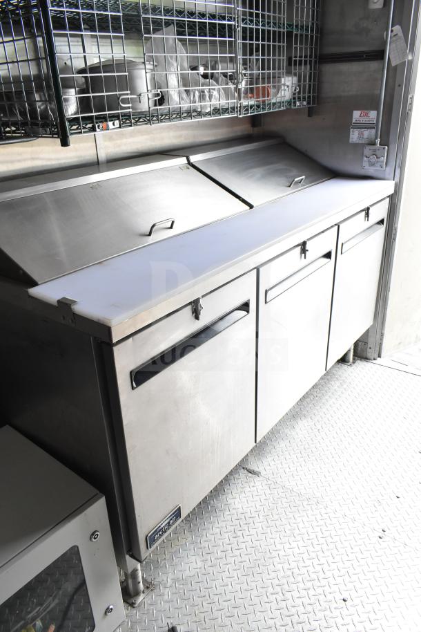 NBRHD Kitchens food trailer interior showing Arctic Air refrigeration and shelving. Clean, equipped for service.