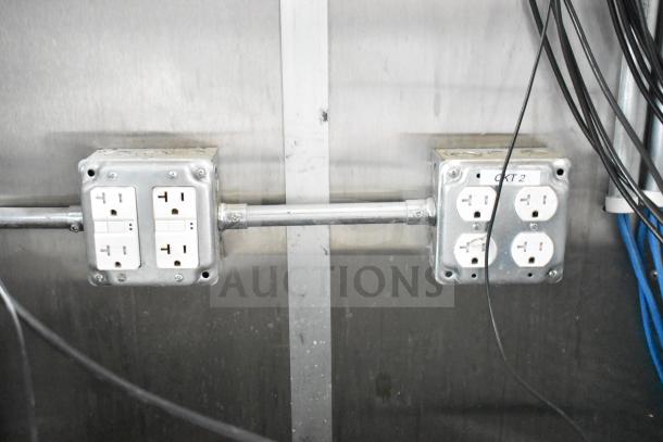 Electrical outlets on a metal wall in the NBRHD Kitchens Ghost Kitchen Food Trailer.