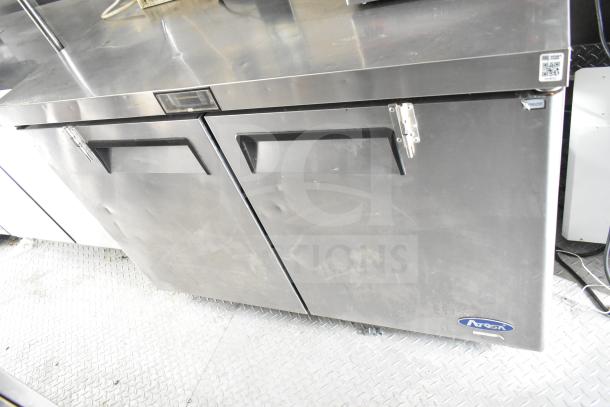 Food trailer refrigeration unit with Arctic Air branding, showing dual doors and a metal finish. Some wear visible.