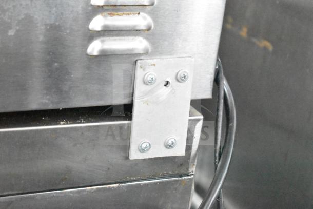 Metal corner detail of the NBRHD Kitchens Ghost Kitchen Food Trailer, showcasing stainless steel construction.