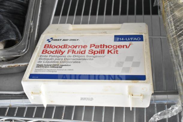 Bloodborne Pathogen/Bodily Fluid Spill Kit with OSHA compliance label, situated on a metal shelf.